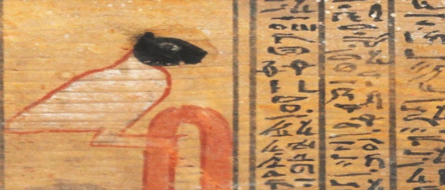 The demon Ikenty represented as a large bird with a black feline head on a Middle Kingdom coffin. The same demon appears as a large bird on a much older leather roll